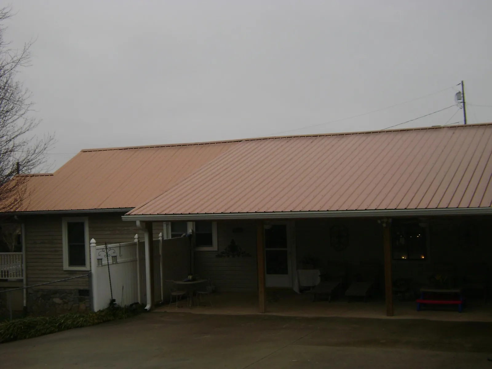 Copper toned metal roof over a wide covered patio in Green Cove Springs